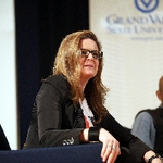 Dr. Jill H. Casid leaning forward to better hear a question